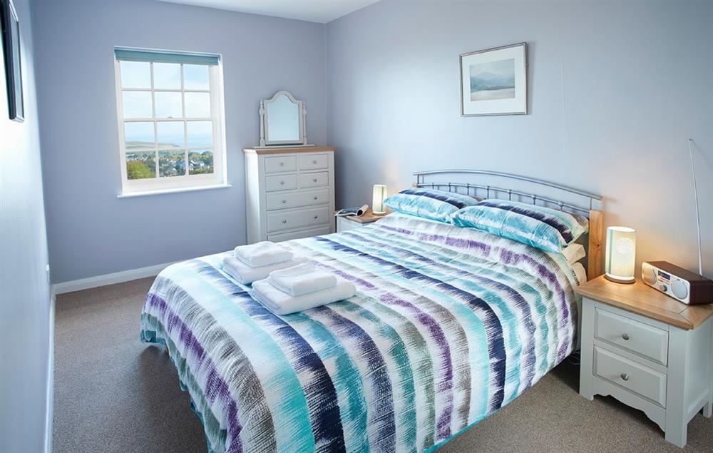 Bedroom one with a 5’ king-size bed at Rhiwelli, Dinas Cross
