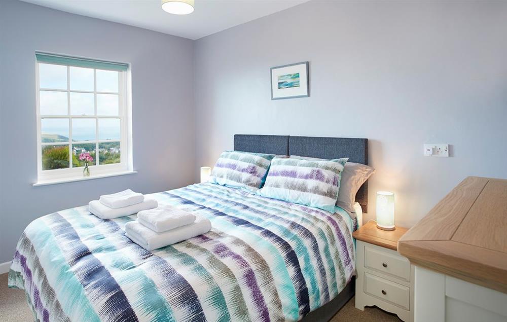 Bedroom two with a 5’ king-size bed at Rhiwelli, Dinas Cross
