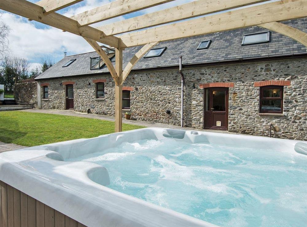 Luxurious hot tub at Rhos Barn in Crugybar, near Llanwrda, Dyfed