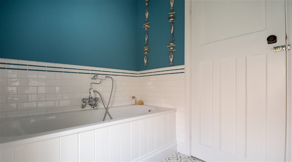 The bathroom with bath with shower attachment, at Rhossili Old Rectory in Rhossili, South Wales