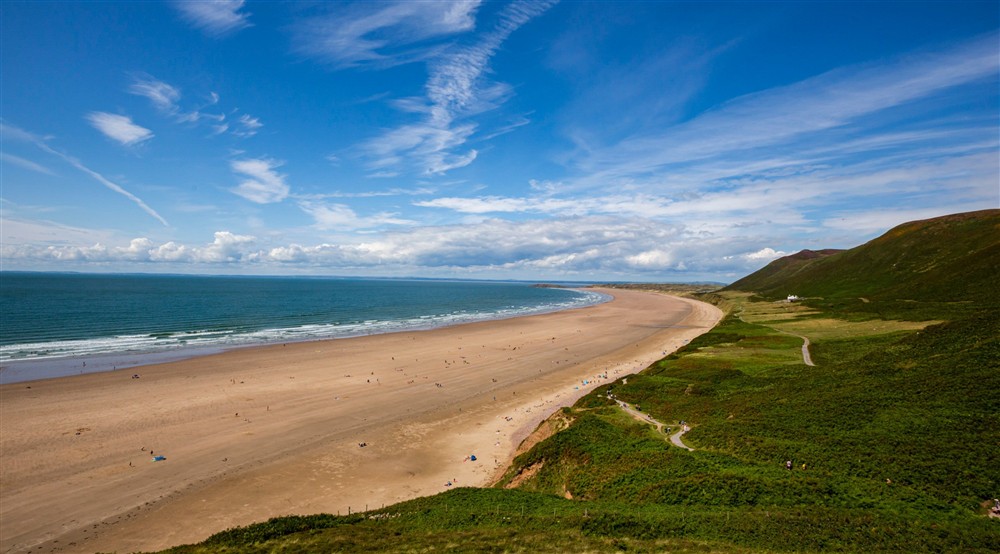 The golden sands of Rhosili beach in summer, surrounded by lush green heather, South Wales at Rhossili Old Rectory in Rhossili, South Wales