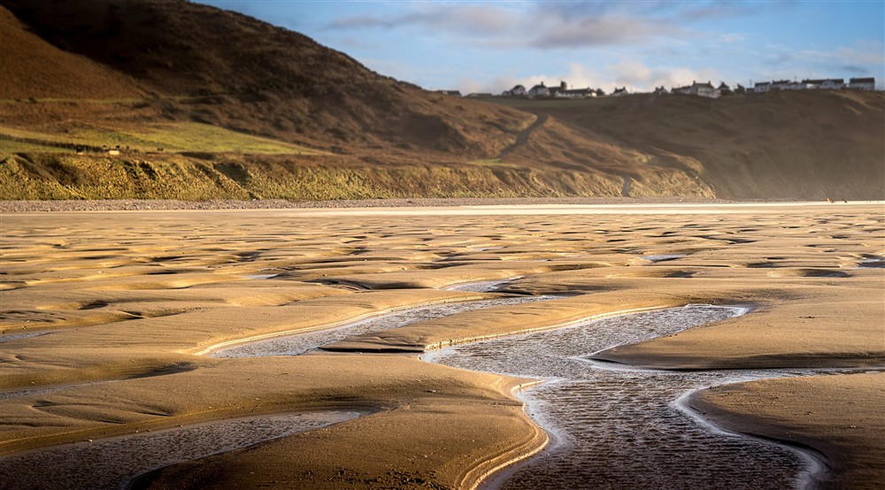 The golden sands of Rhossili Bay Beach with the hills of Rhossili Down in the background, near Rhossili Old Rectory, South Wales at Rhossili Old Rectory in Rhossili, South Wales