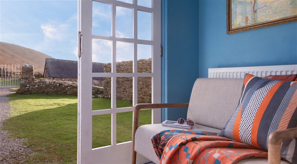 The porch with a bench, which leads to the dining room at Rhossili Old Rectory in Rhossili, South Wales