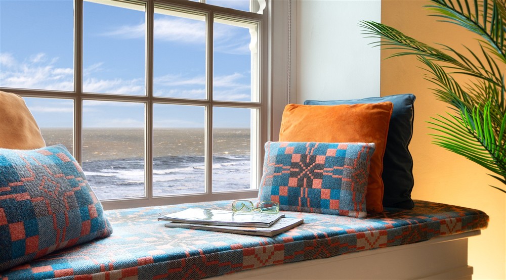 The window seat with sea views, in the snug at Rhossili Old Rectory in Rhossili, South Wales