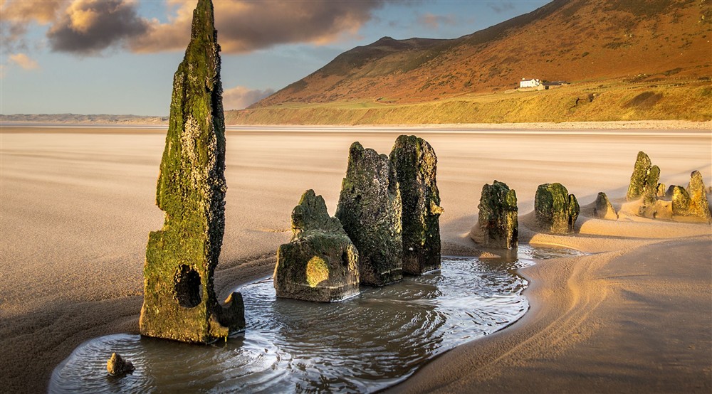 The wreck of the Helvetia, which sank in 1887, visible on Rhosili Bay Beach at Rhossili Old Rectory in Rhossili, South Wales