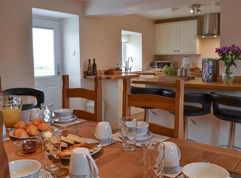 Kitchen with dining area at Rhosydd Cottage in Llandyfrydog, near Amlwch, Anglesey, Gwynedd