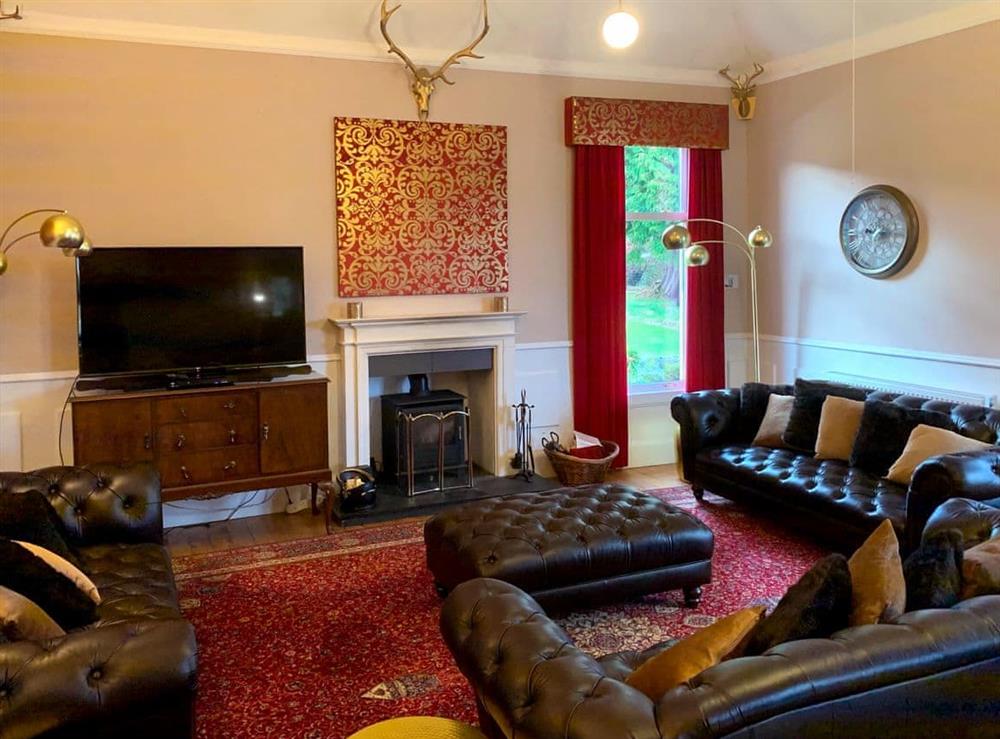 Comfortable living room with wood burner at Rhumhor House in Carrick Castle, near Lochgoilhead, Argyll