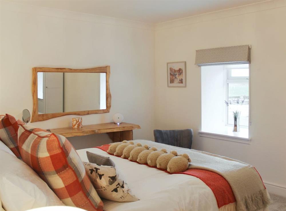 Main bedroom with feature dressing table at Rhunahaorine Cottage in Tayinloan, near Tarbert, Argyll