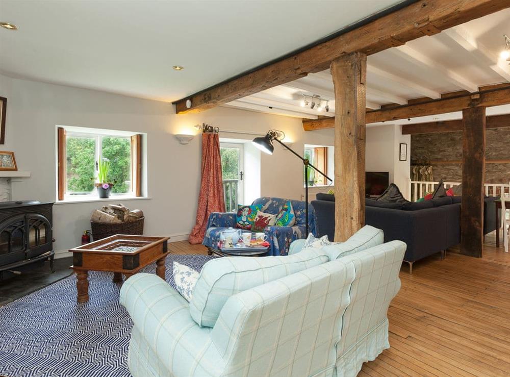 Charming living room with multiple seating areas at Rhydloes Mill in Llansilin, near Oswestry, Powys