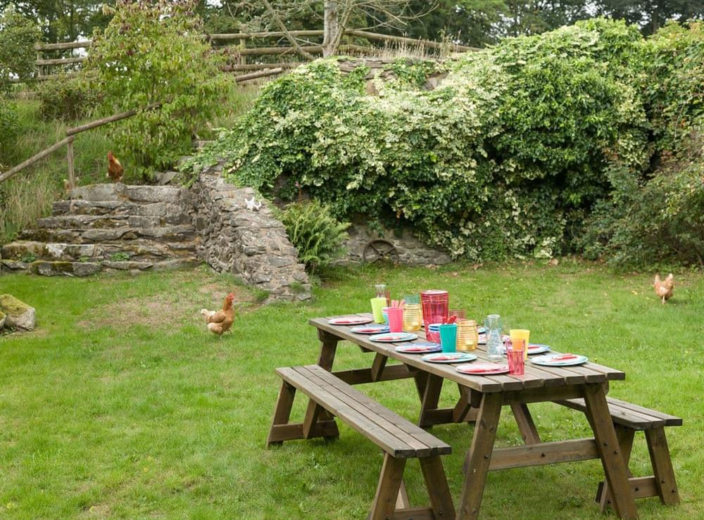 Outdoor furniture within the garden at Rhydloes Mill in Llansilin, near Oswestry, Powys