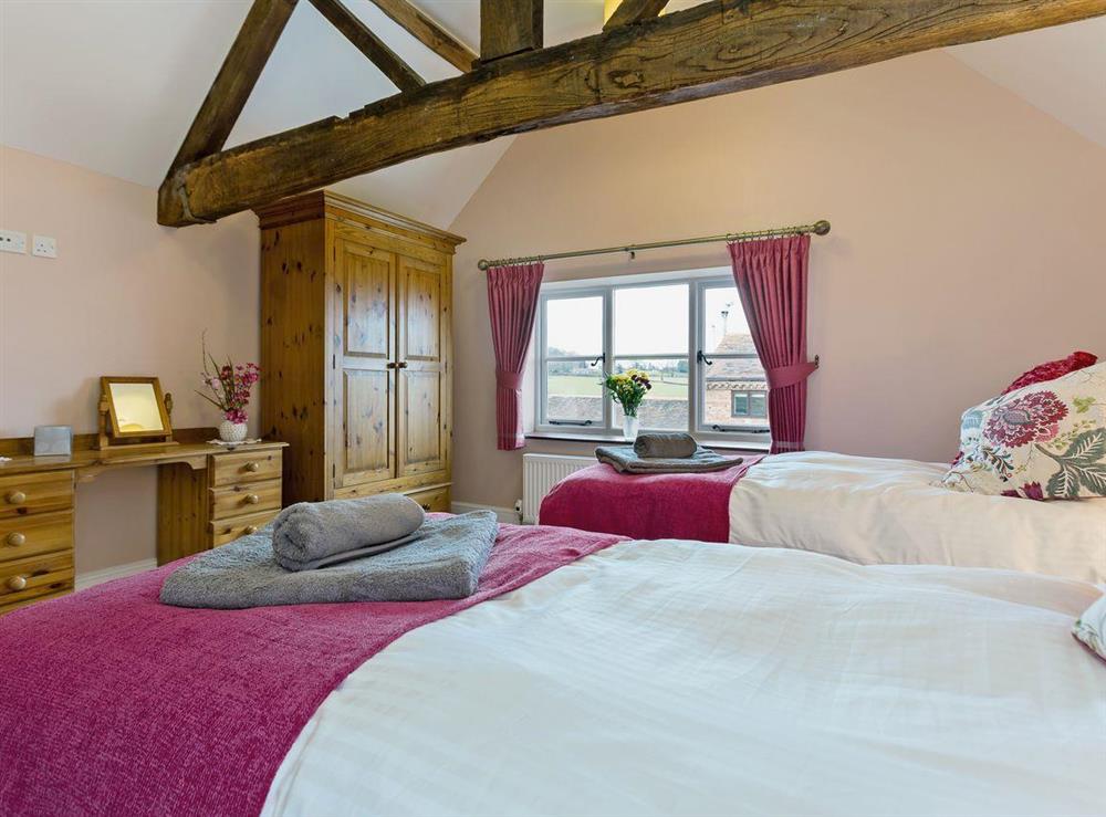 Twin bedroom with beamed ceiling at Rimmers Farmhouse in Wichenford, near Worcester, Worcestershire