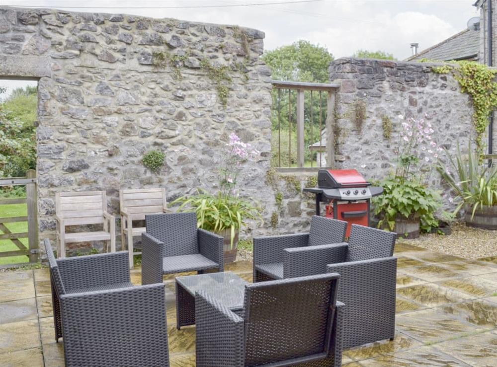 Private courtyard with outdoor furniture at Ringslade Barn in Highweek, near Newton Abbot, Devon