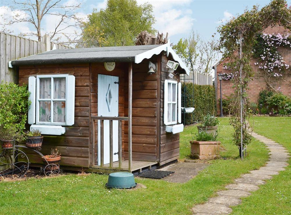 Charming playhouse in the garden at Ringstead Cottage in Ringstead, Norfolk