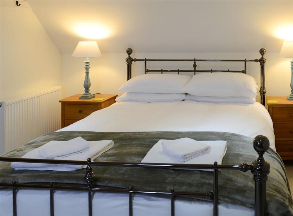 Romantic double bedroom with antique style kingsize bed at The Fish House, 