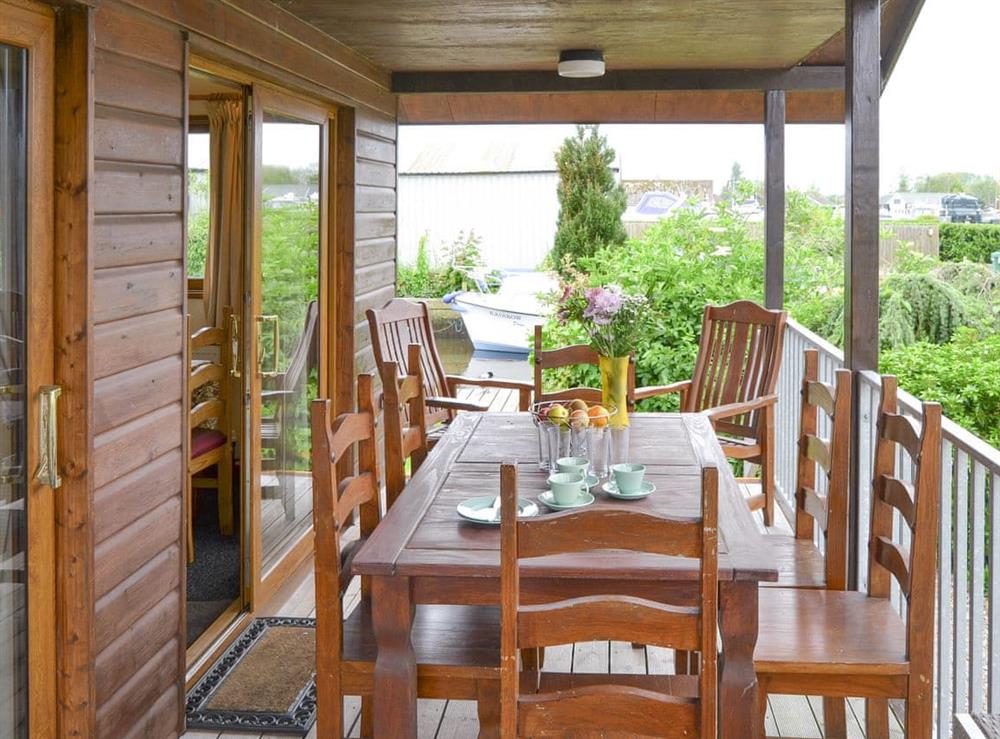 Outdoor dining area on the terrace at River Breeze in Brundall, Norfolk