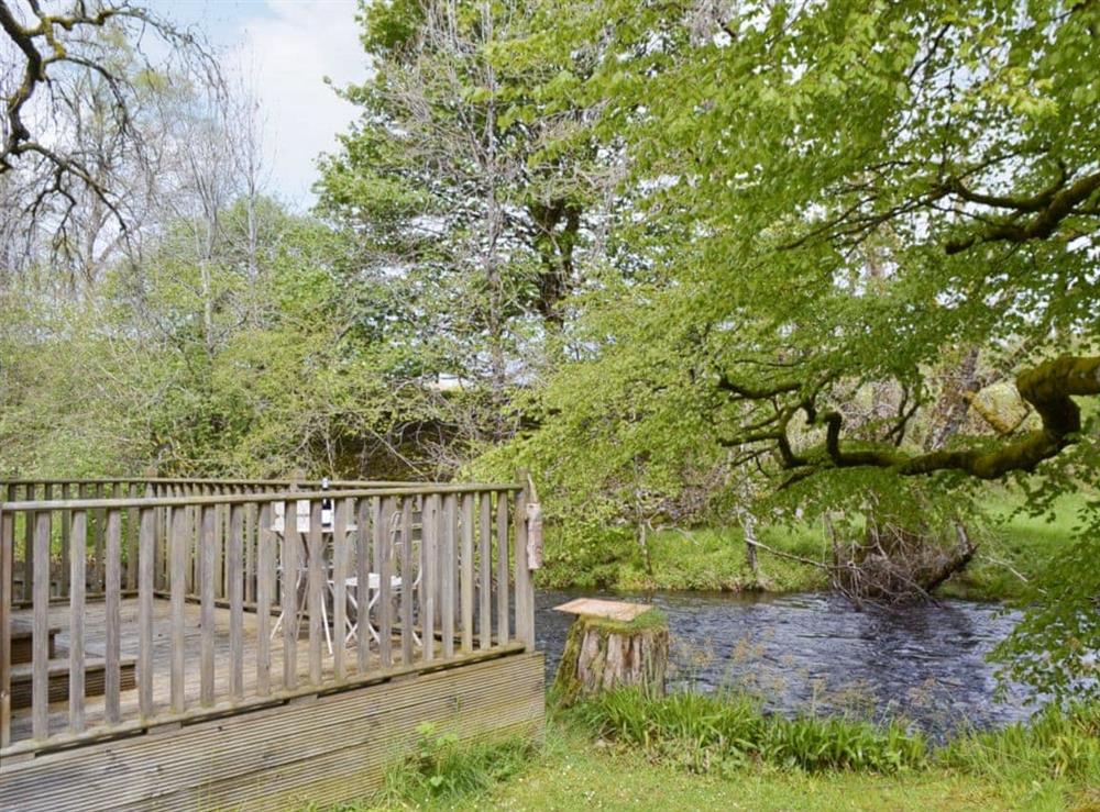 Decking overlooking river at River Cottage in Enochdhu, Perthshire., Great Britain