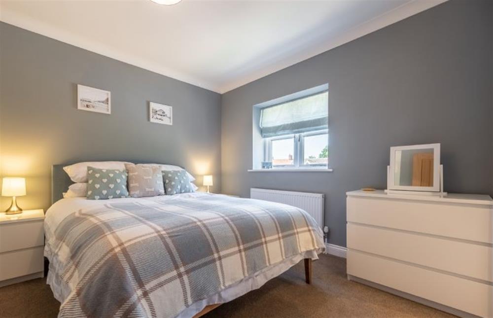 Master bedroom with king-size bed at River Cottage, Heacham near Kings Lynn