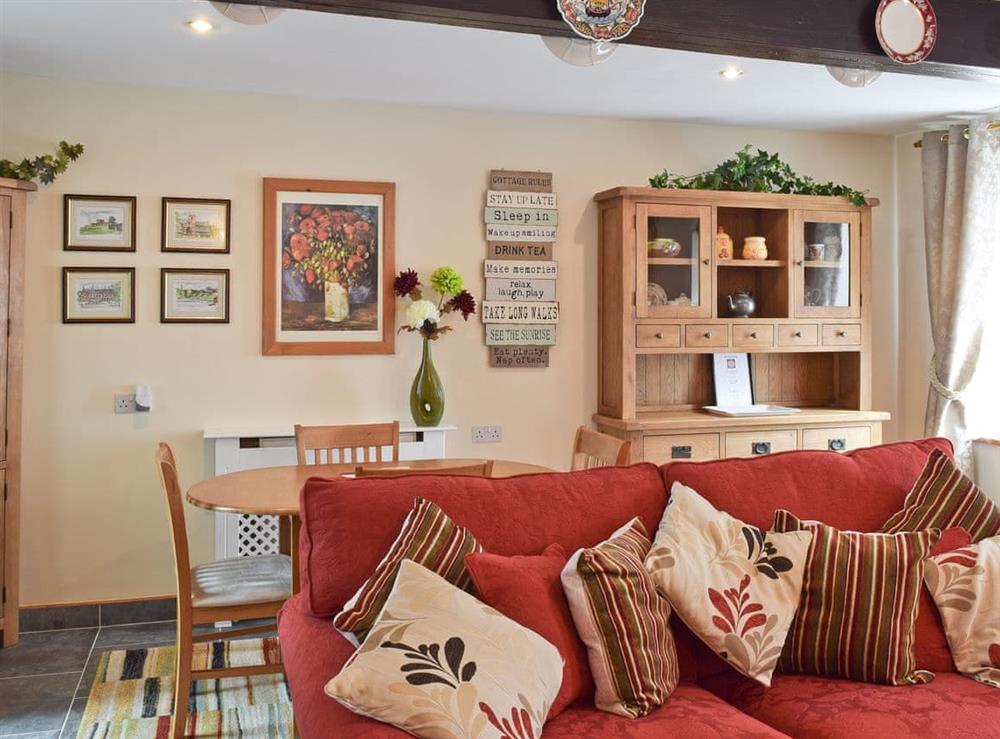 Living room with dining area at River Cottage in Keswick, Cumbria