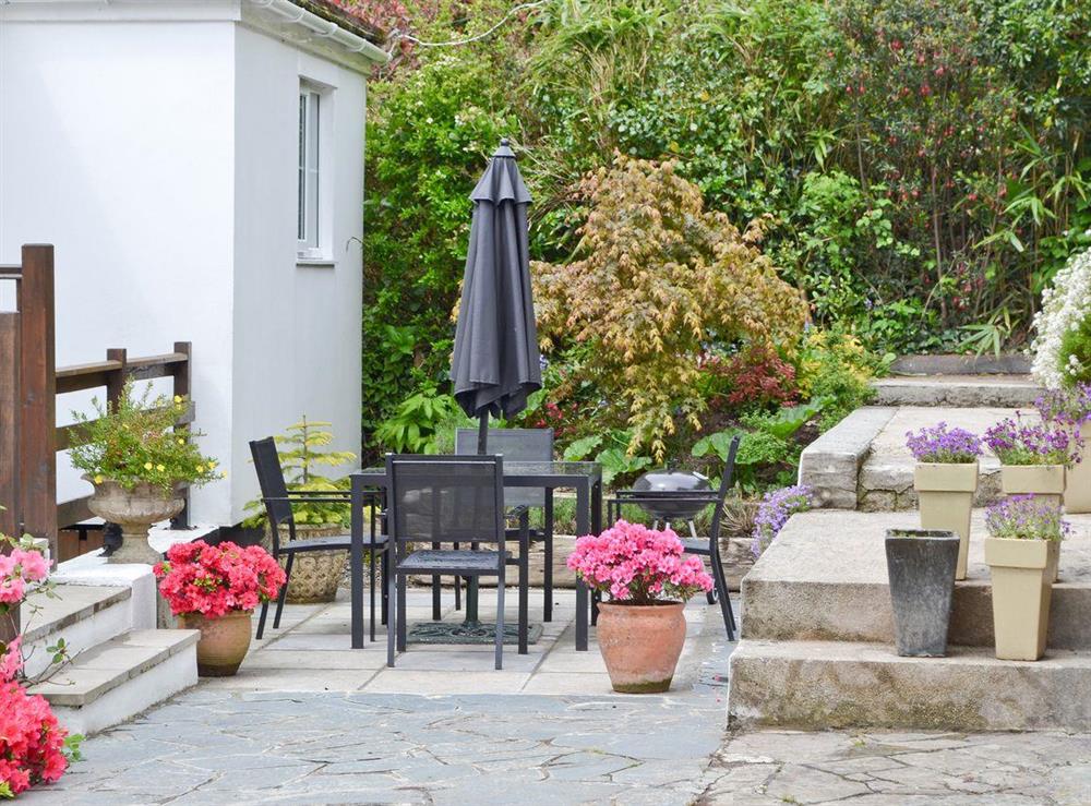 Inviting patio with furniture and barbecue at River Lodge in Polperro, near Looe, Cornwall