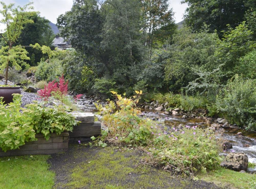 A delightful stream gently flows alongside the garden at River Mill House in Ballachulish, near Fort William, Argyll