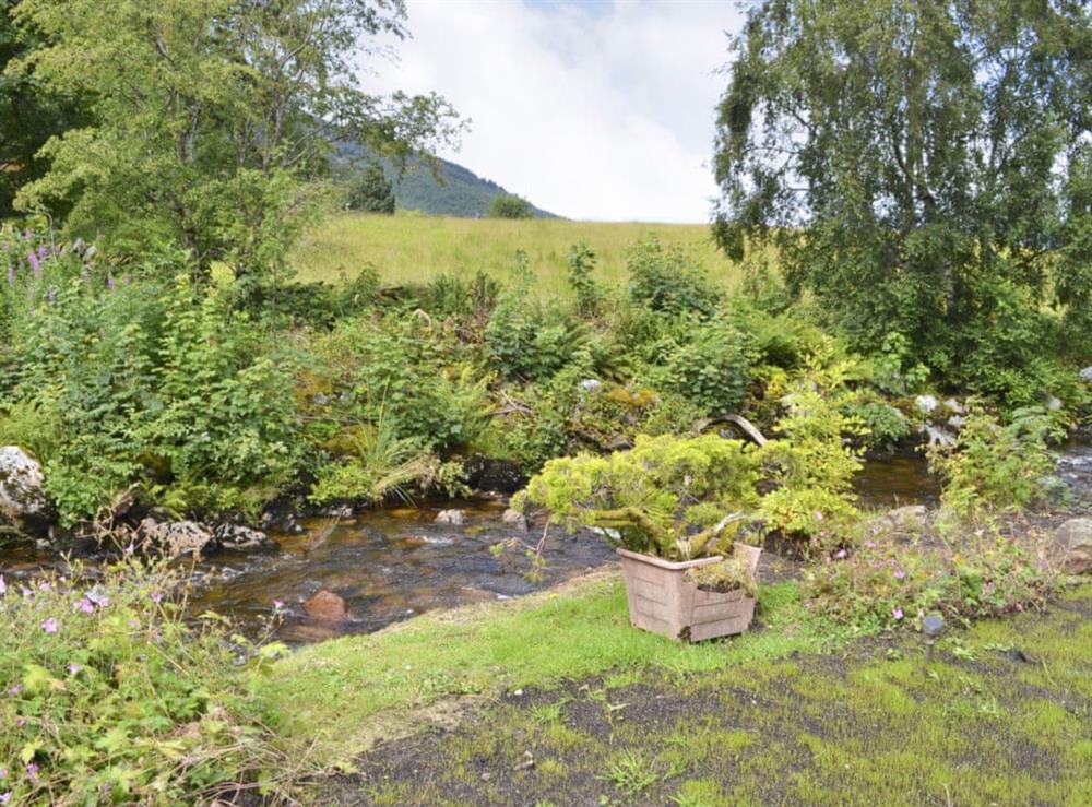 A gentle stream flows next to the garden at River Mill House in Ballachulish, near Fort William, Argyll