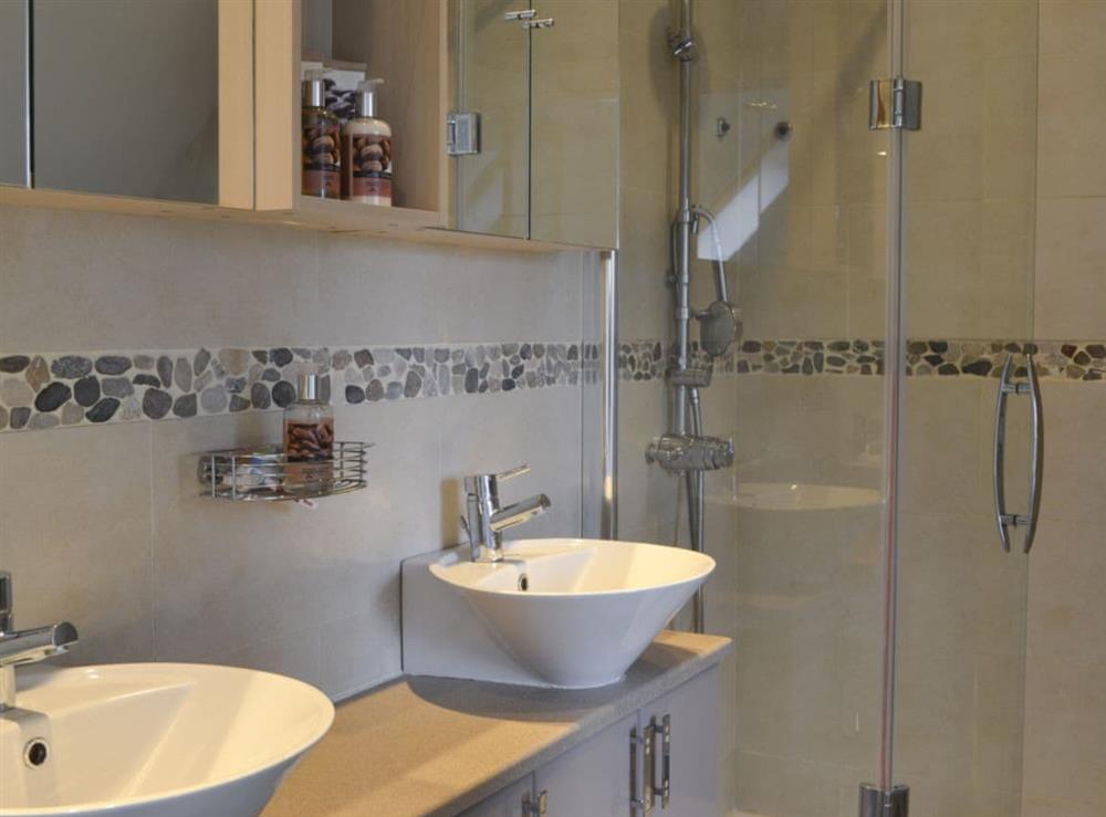 En-suite bathroom with bath, shower cubicle and toilet at River Mill House in Ballachulish, near Fort William, Argyll