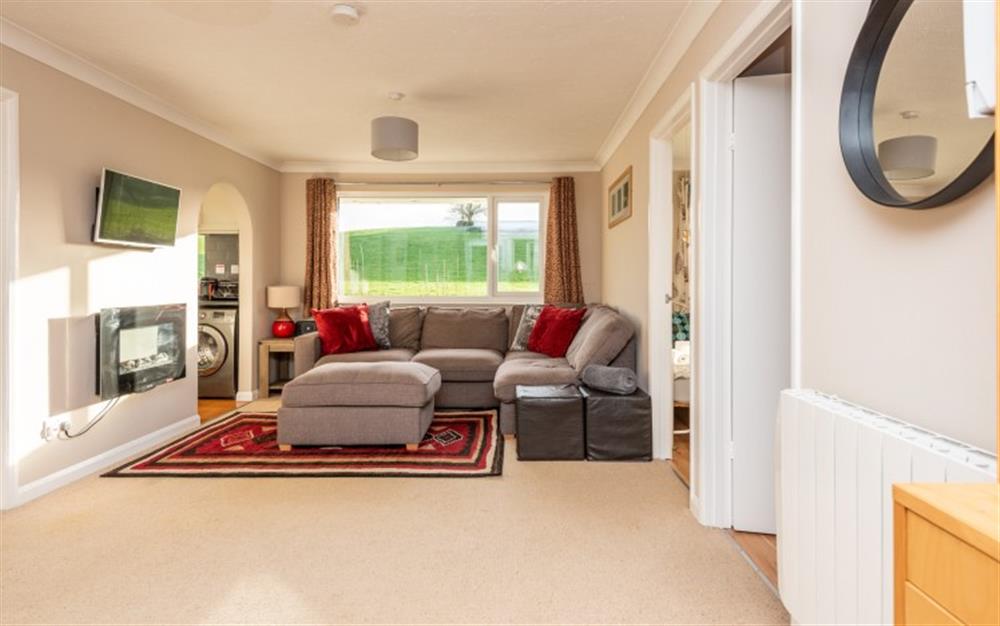 Spacious open plan living with corner sofa and stunning views. at River Retreat in Liskeard
