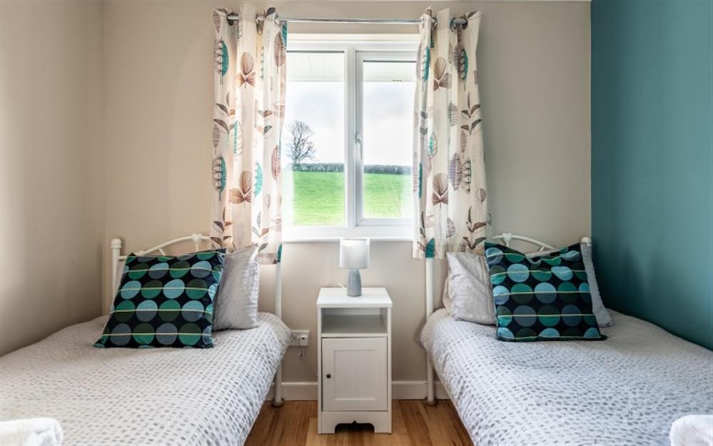Twin bedroom with two 3ft single beds. at River Retreat in Liskeard