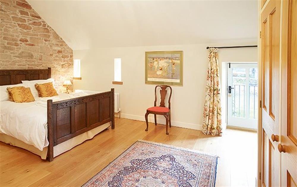 Double bedroom with 5’ bed with en-suite bathroom with shower over bath at Riverain, Nr Greystoke