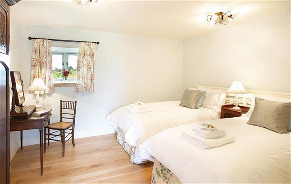Double bedroom with 6’ zip and link beds with en-suite shower room at Riverain, Nr Greystoke