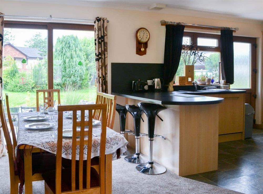 Dining area with patio doors to the garden at Riverside in Brydekirk, Annon, Dumfriesshire