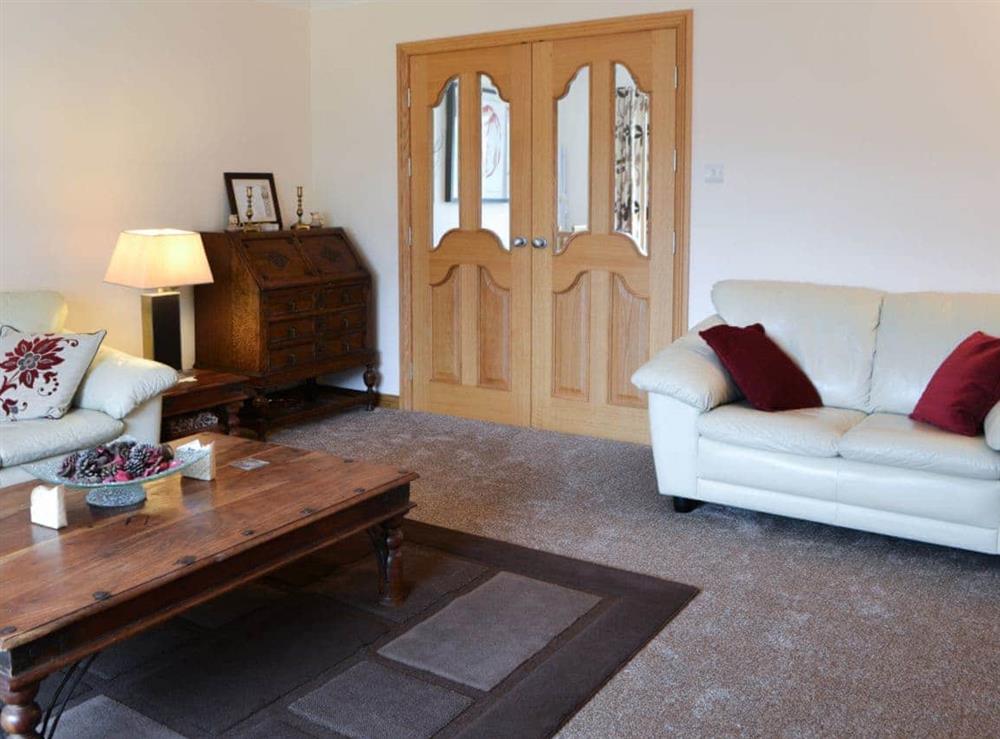 Living room with double doors to the kitchen/diner at Riverside in Brydekirk, Annon, Dumfriesshire