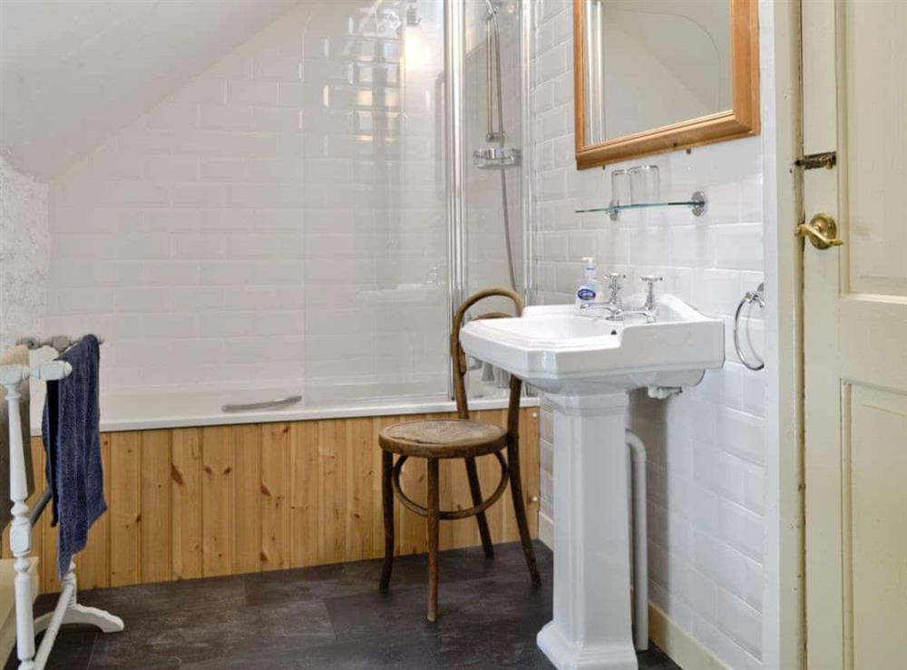 Family bathroom with shower over bath at Riverside Cottage in Betws-y-Coed, Gwynedd