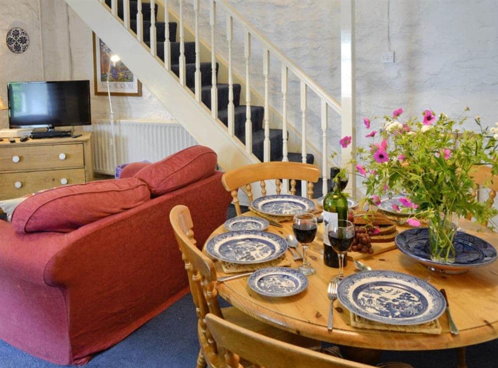 Stairs to upper level in living/dining room at Riverside Cottage in Betws-y-Coed, Gwynedd