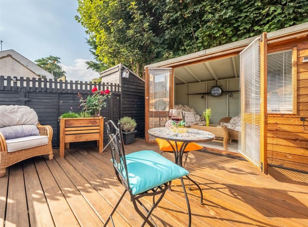 Decked area with summerhouse at Riverside Cottage in Reedham, near Brundall, Norfolk