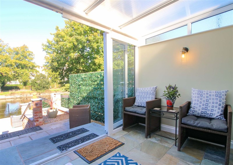 Enjoy a glass of wine on the patio at Riverside Cottage, Shrewsbury