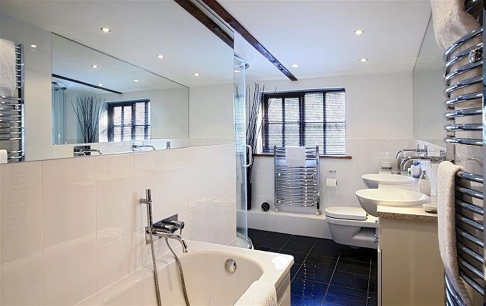 First floor: Family bathroom with bath, twin basins and separate shower at Riverside Cottage (Suffolk), Old Water Mill