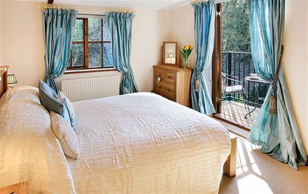 First floor: Master bedroom with 5' bed and balcony at Riverside Cottage (Suffolk), Old Water Mill