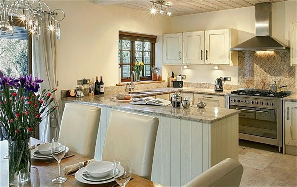 Ground floor: Open plan dining room with patio doors onto outdoor, decked seating area with kitchen behind