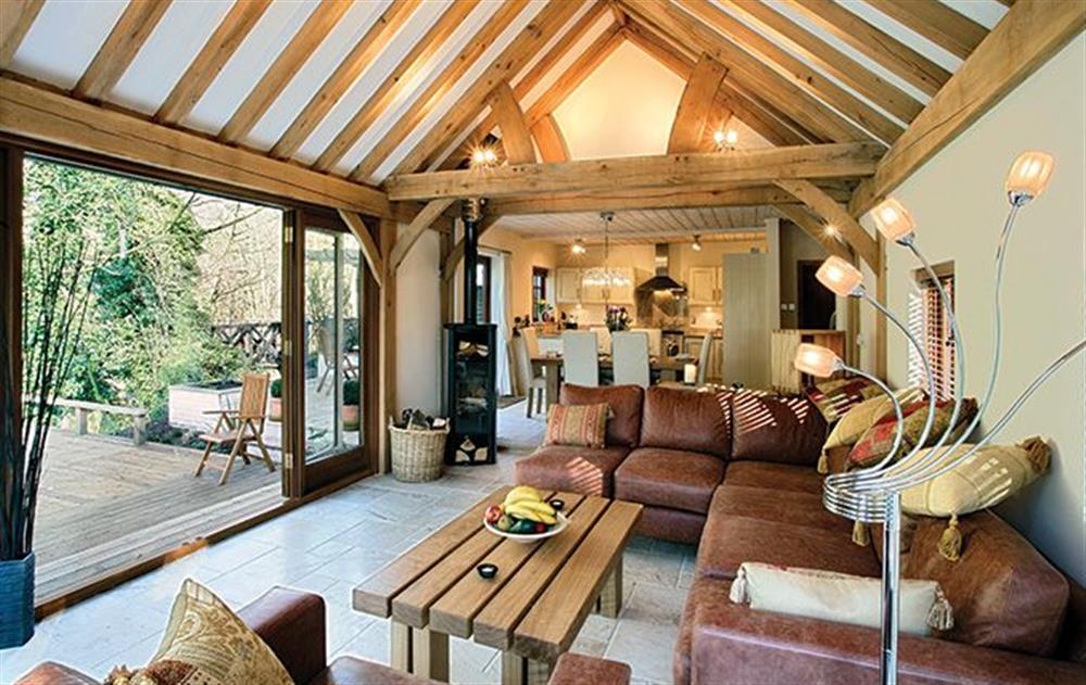 Ground floor: Open plan living space with wood burning stove, adjoining dining room and kitchen at Riverside Cottage (Suffolk), Old Water Mill