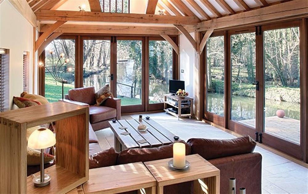 Ground floor: Sitting area with wood burning stove at Riverside Cottage (Suffolk), Old Water Mill