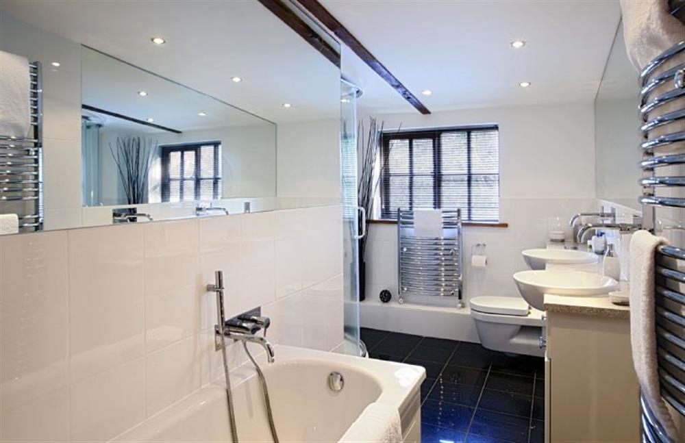 First floor:  Family bathroom with bath, twin basins and separate shower at Riverside Cottage, Syleham near Eye