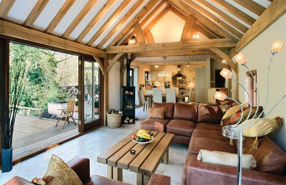 Riverside Cottage:  Open-plan living area with wood burning stove, adjoining dining room and kitchen at Riverside Cottage, Syleham near Eye