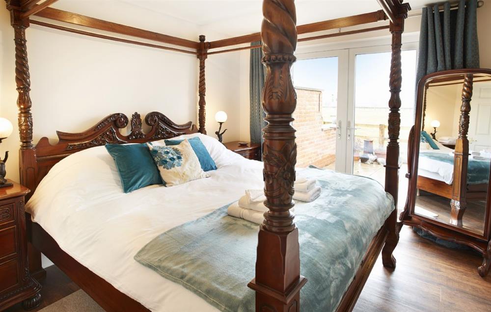 Master bedroom with four poster super-king bed at Riverside Farm Cottage, Kirby Mills, Kirkbymoorside
