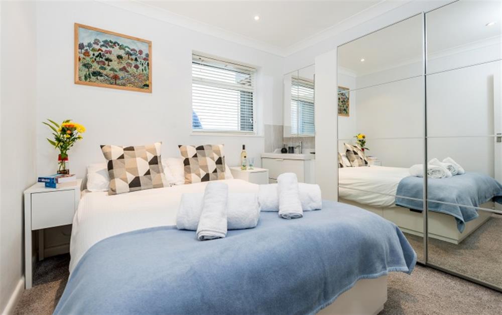 The master bedroom which is at the rear of the apartment, has a 5ft bed plus large mirror fronted wardrobes. at Riverside in Helford Passage