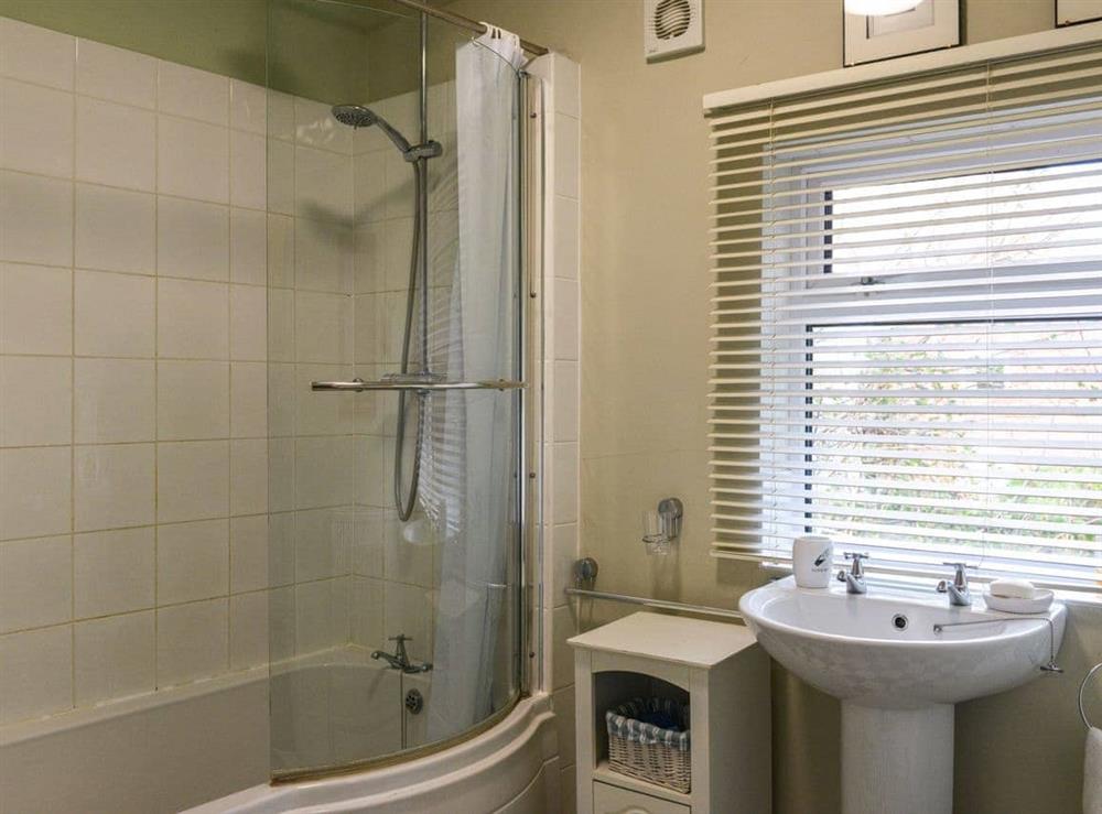 Family bathroom with shower over bath at Riverside House in Beccles, Suffolk