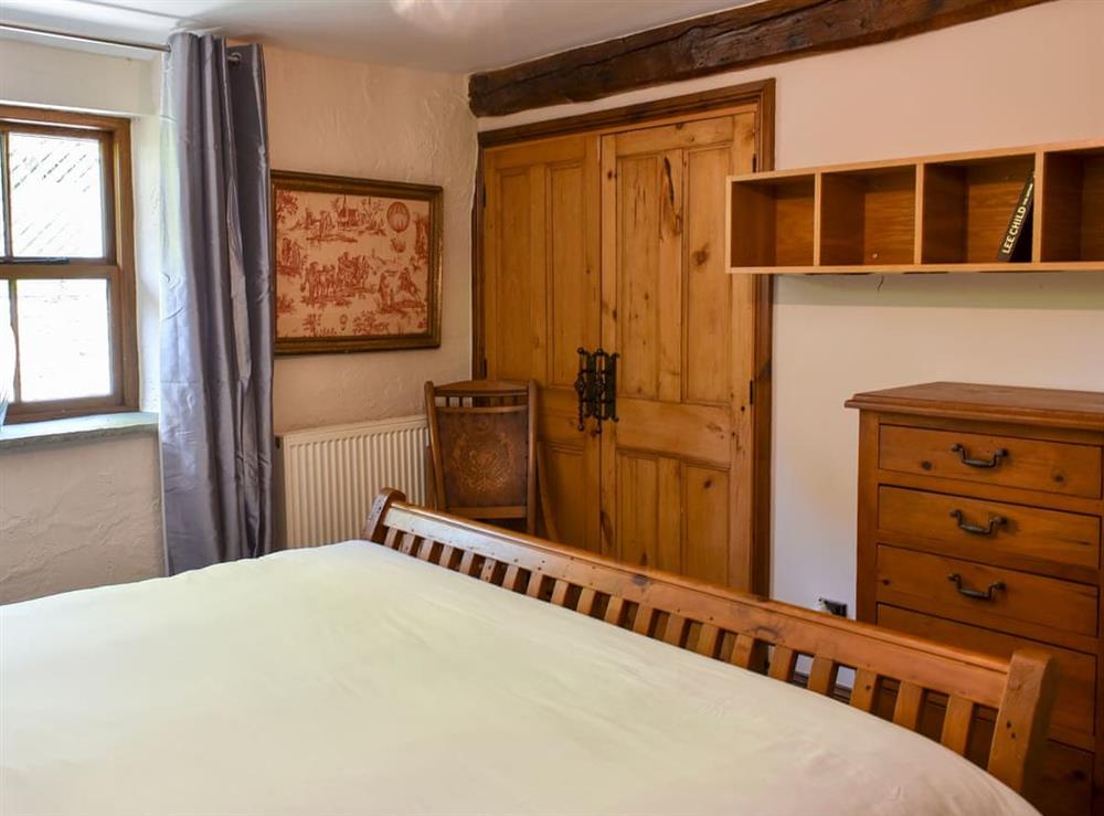 Tranquil bedroom with super kingsize bed (photo 2) at Riverside Mill & Glamping Pod in Patton, near Kendal, Cumbria