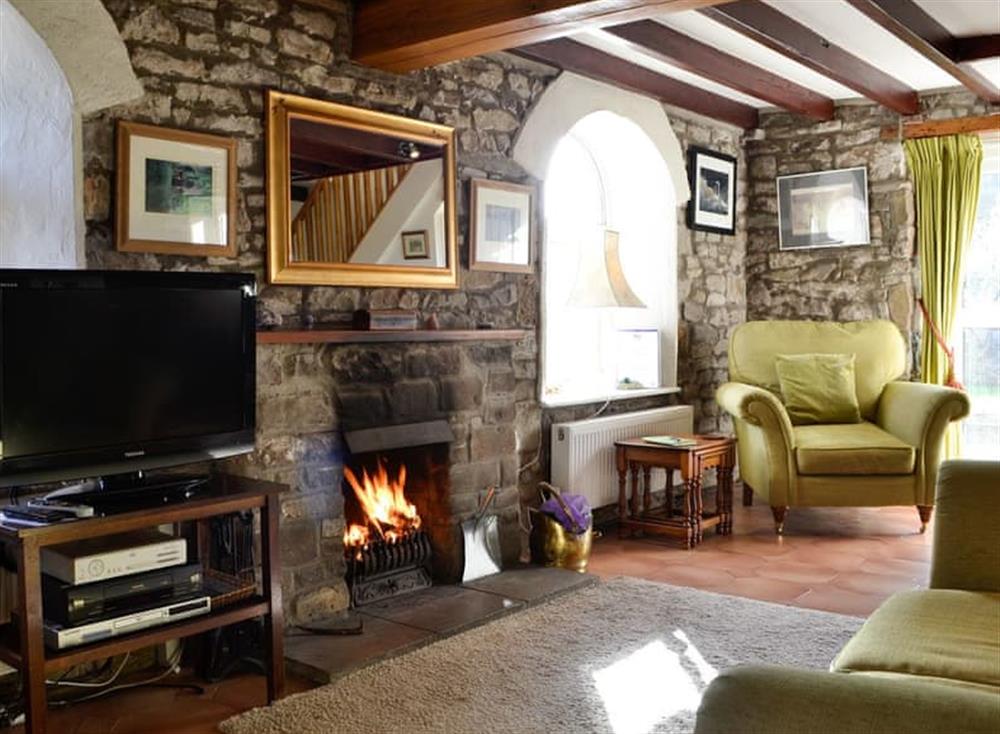 Cosy living room with open fire at Riverside in Tintern, near Monmouth, Gwent
