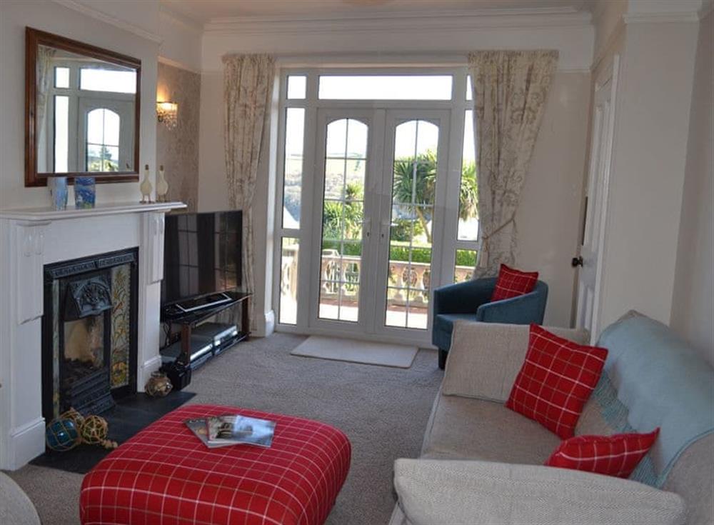 Stylish sitting room with French door leading out onto the patio at Riverview, 20 Park Road in Fowey, Cornwall