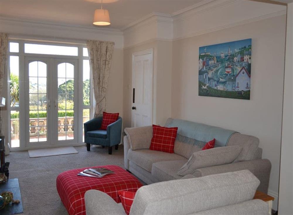 Stylish sitting room with French doors leading out onto the patio at Riverview, 20 Park Road in Fowey, Cornwall
